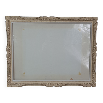 Frame in carved wood patinated