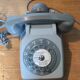 Old vintage wired dial phone with its earphone, gray color. Late 70s - early