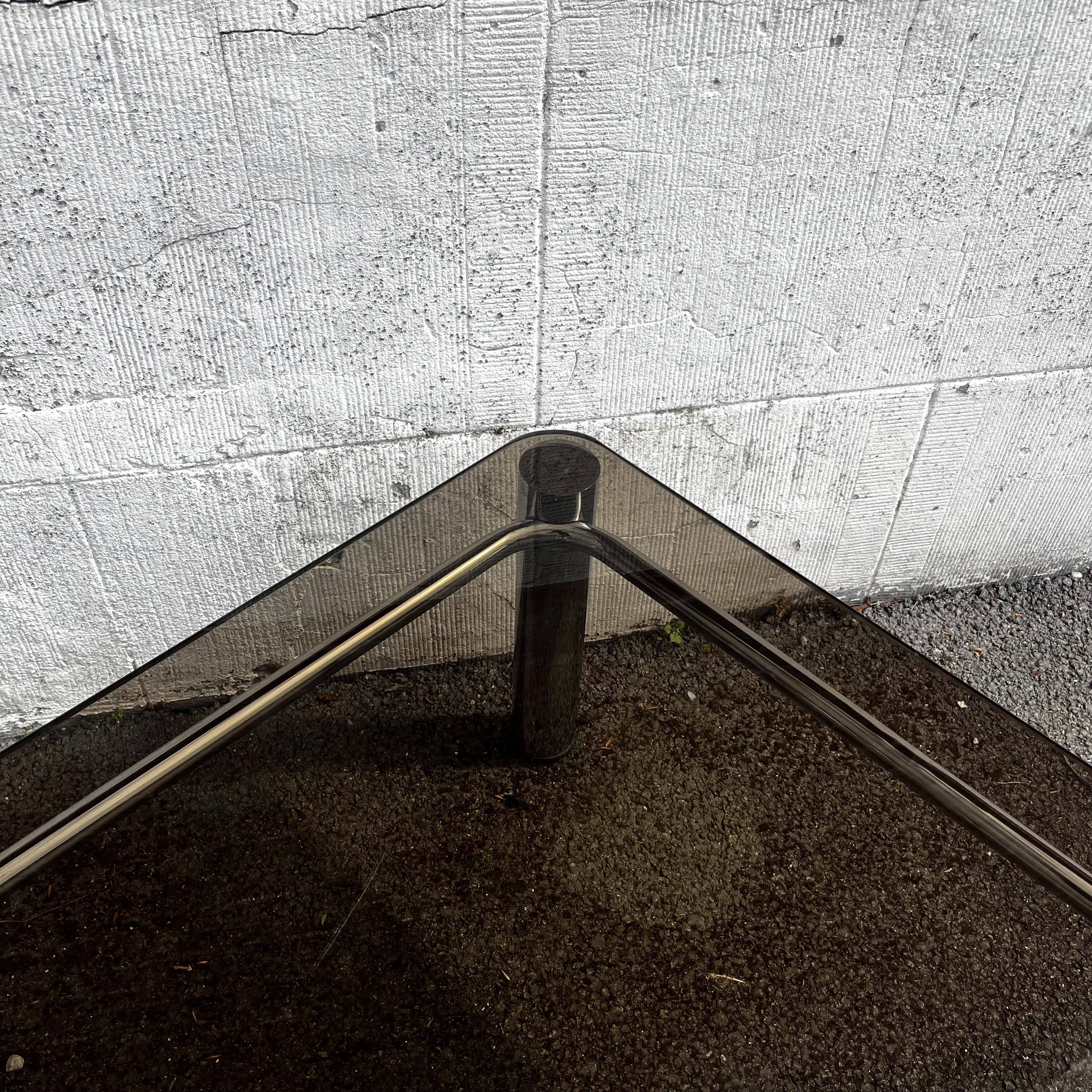 Vintage smoked glass coffee table with chrome structure.