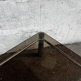 Vintage smoked glass coffee table with chrome structure.