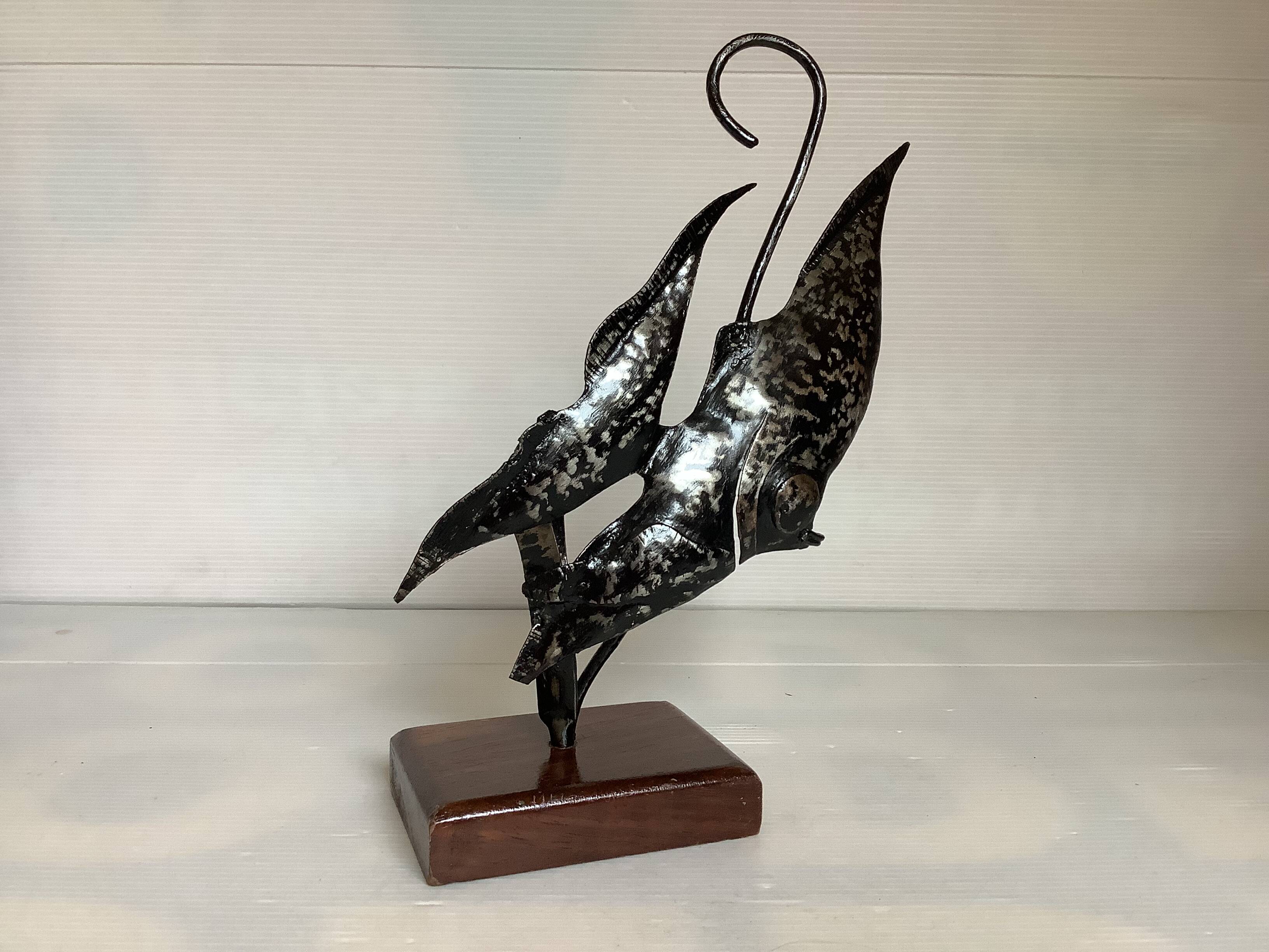 Small metal and wood fish statue