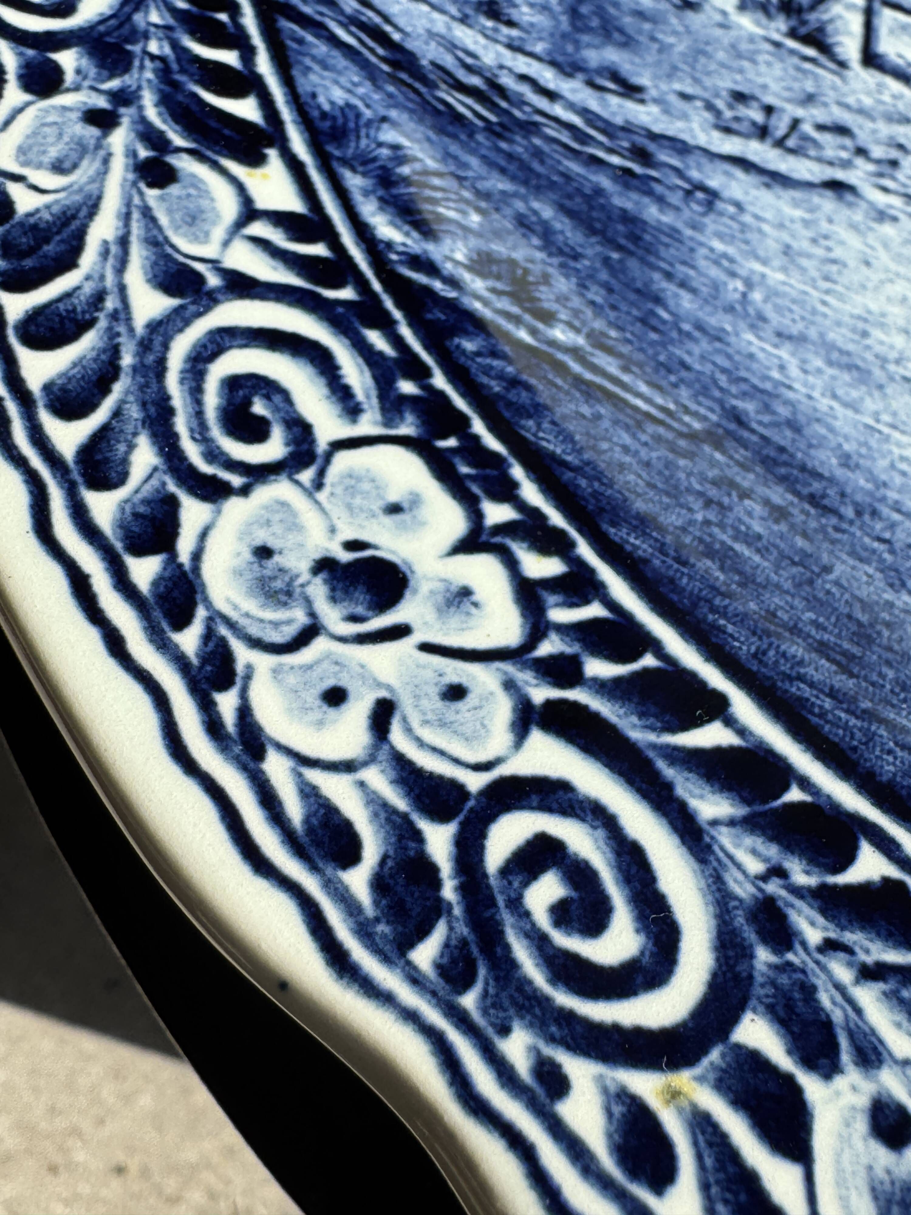 Vintage hollow circular plate in blue and white Boch pottery.