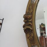 Oval wall mirror, golden floral pattern in stucco and wood, late 19th century