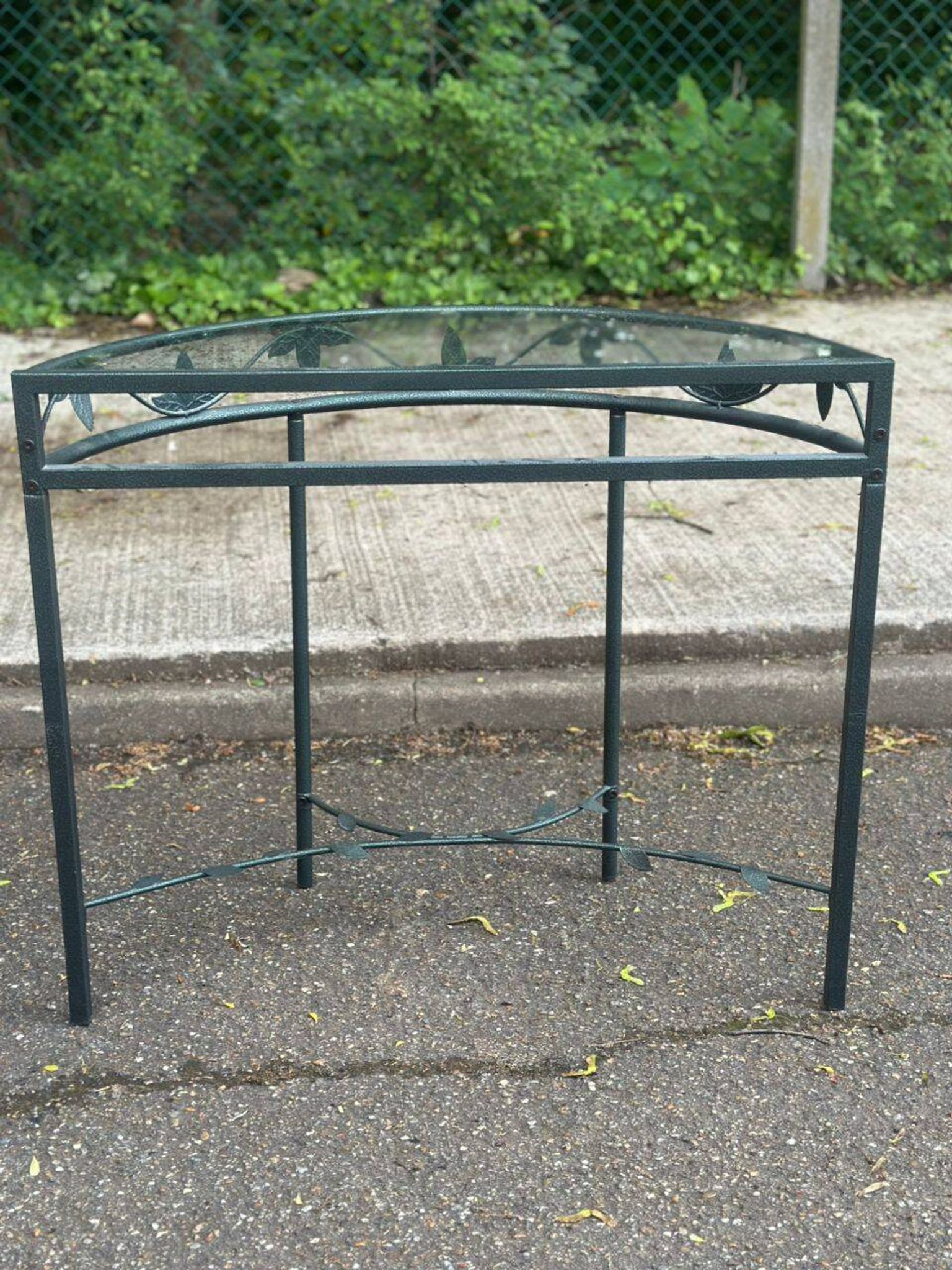 Grey-green wrought iron half-moon console with glass, 85cm.