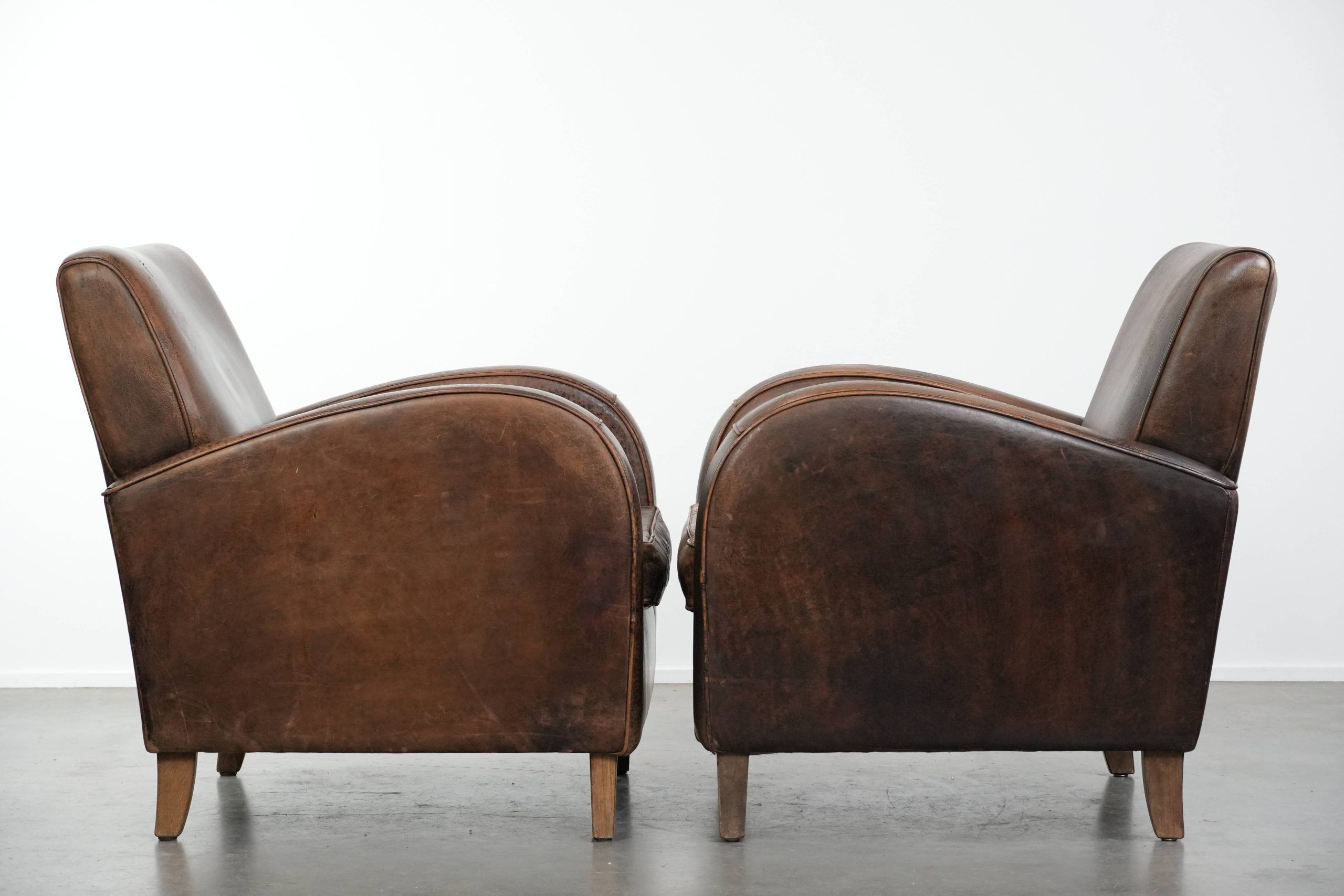 Set of two vintage sheepskin leather design armchairs in a cognac colour