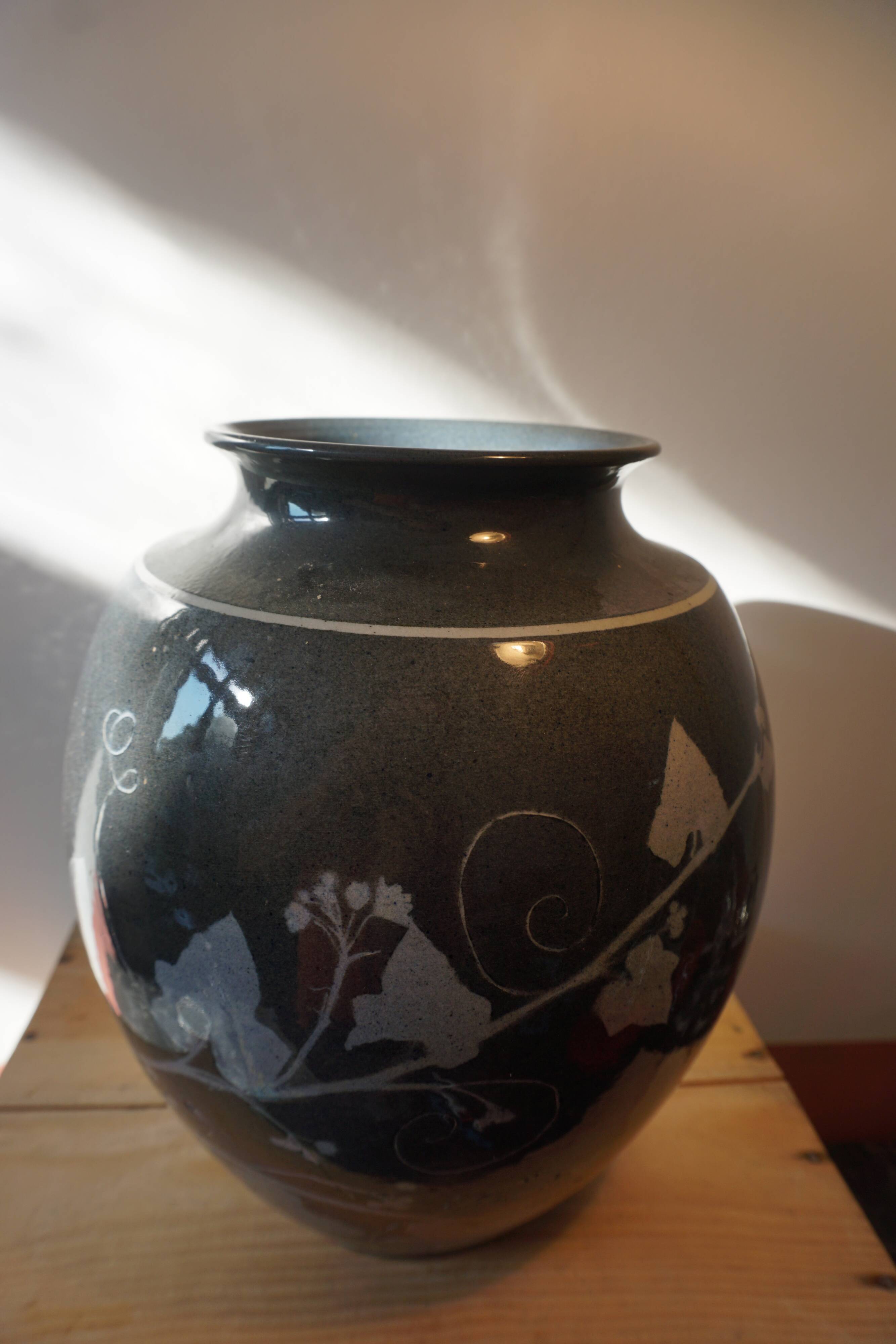 Black vase with plant decoration by Philippe Jacques