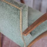 Art Deco armchair in wood and green fabric, living room armchair, interior decor.
