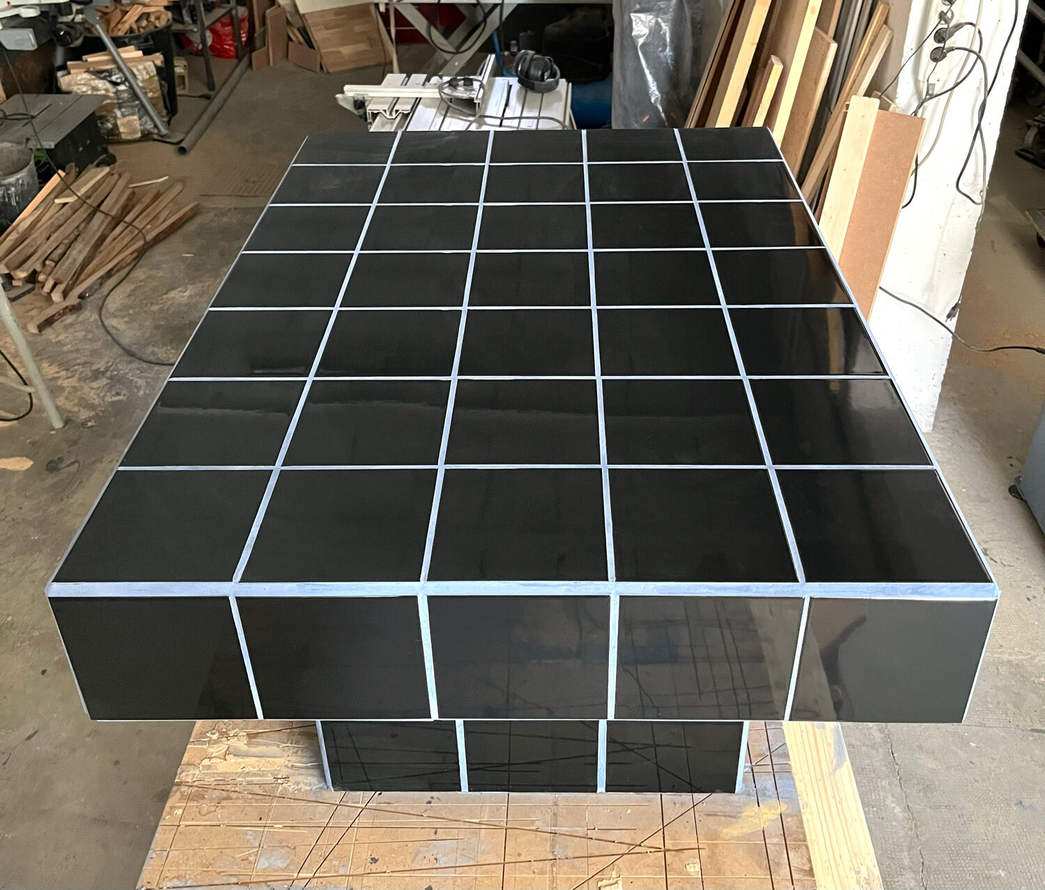 Black tiled coffee table and midnight blue grout