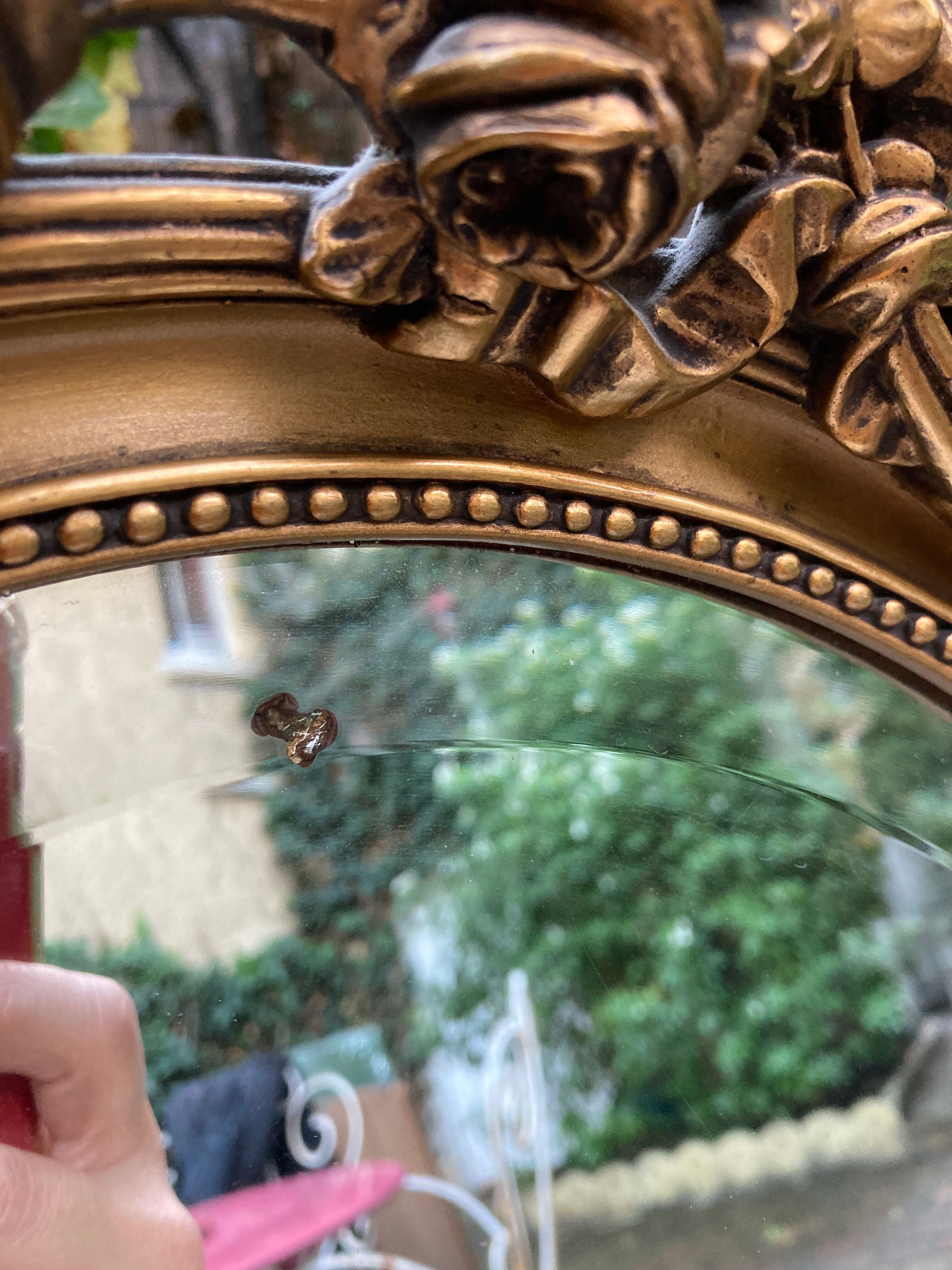 Bevelled oval mirror in vintage gilded wood 46x62cm