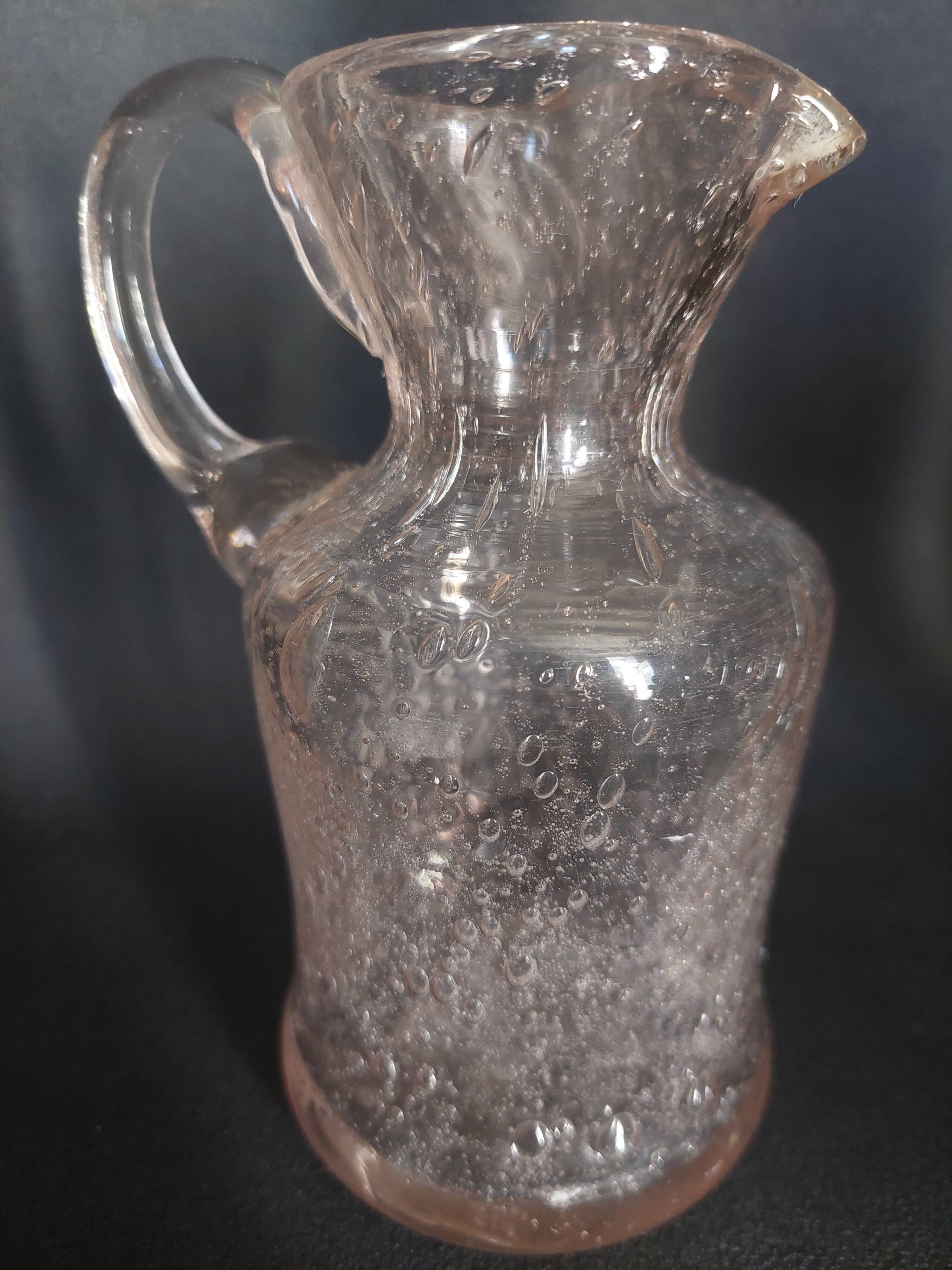Small blown glass pitcher with bubbles from the 20th century.