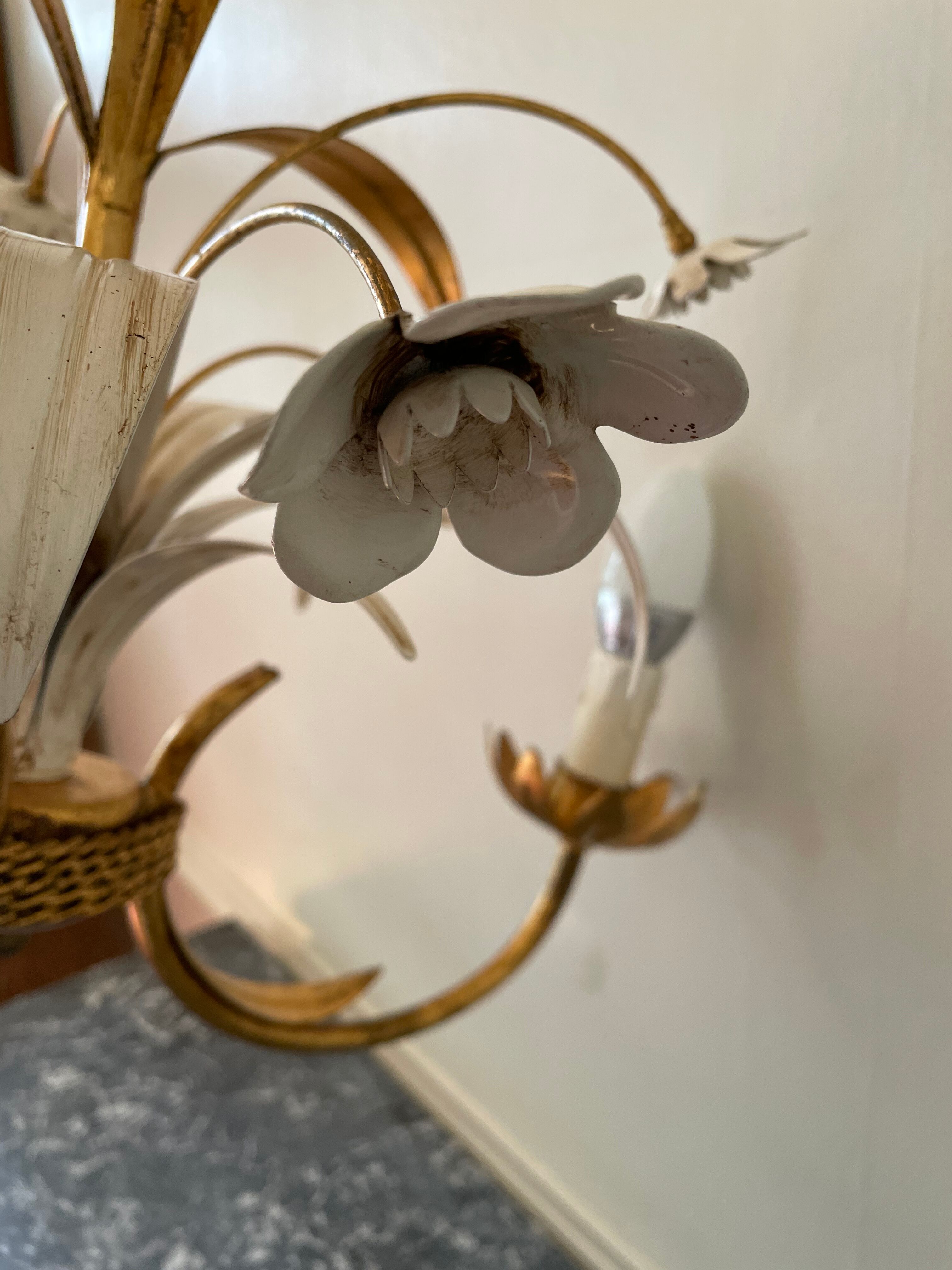 Golden metal chandelier decorated with flowers