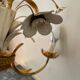 Golden metal chandelier decorated with flowers