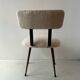 Low seat in metal and white boucle fabric.