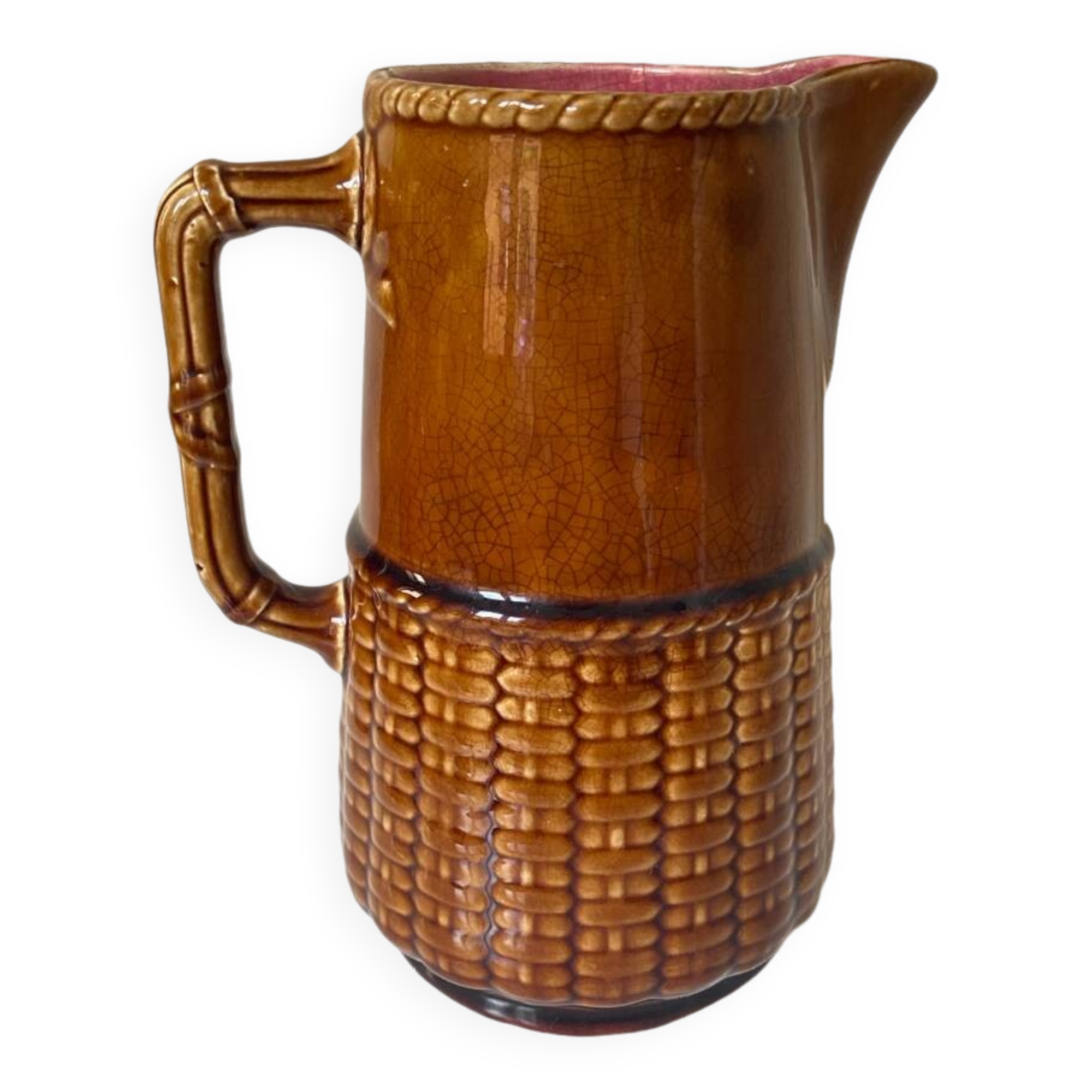 Antique vintage ceramic pitcher or jug from Sarreguemines, France. Brown with a pink interior, imitation basket.