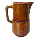 Antique vintage ceramic pitcher or jug from Sarreguemines, France. Brown with a pink interior, imitation basket.
