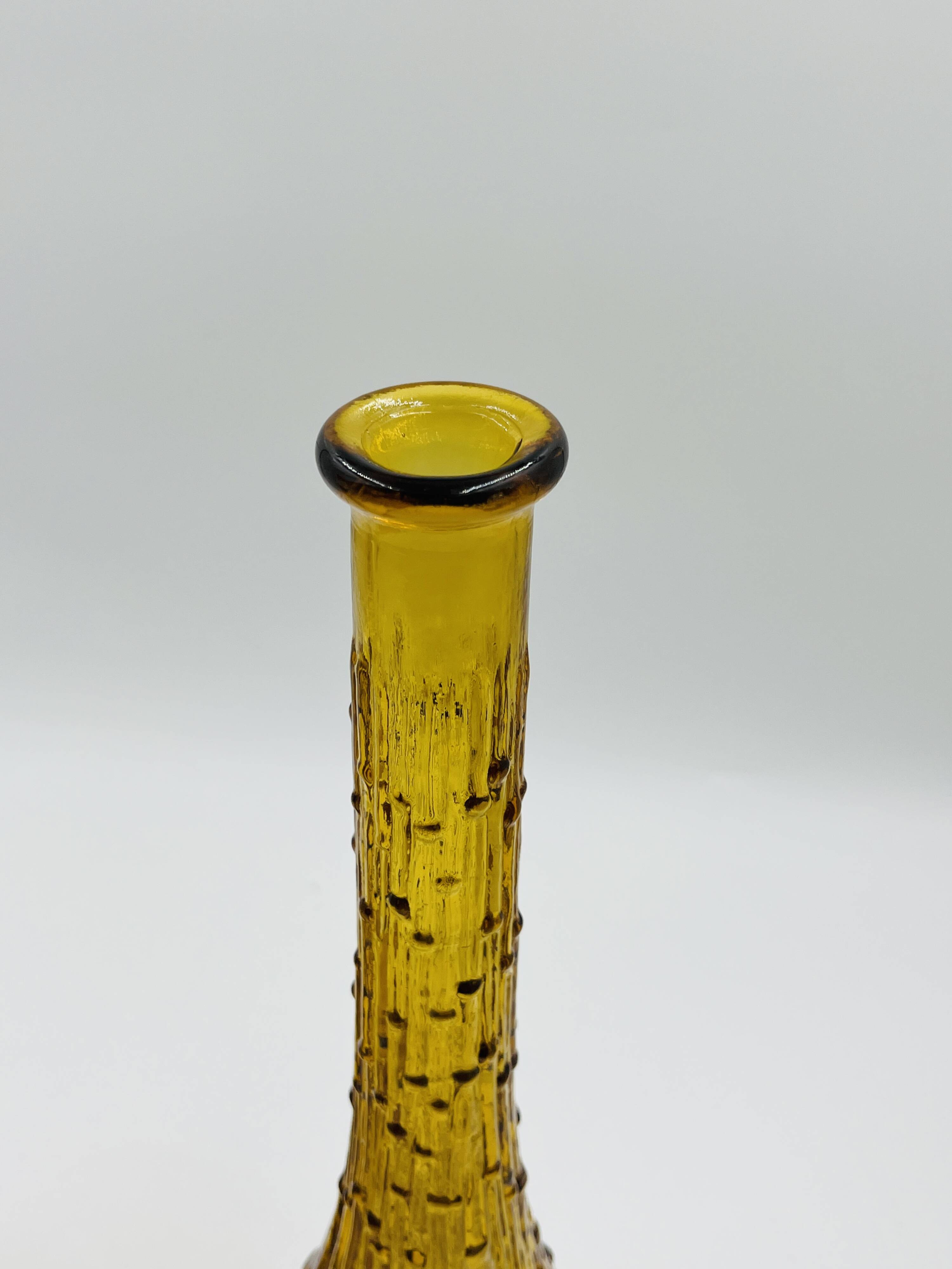 Set of two vintage textured amber glass Empoli bottles.