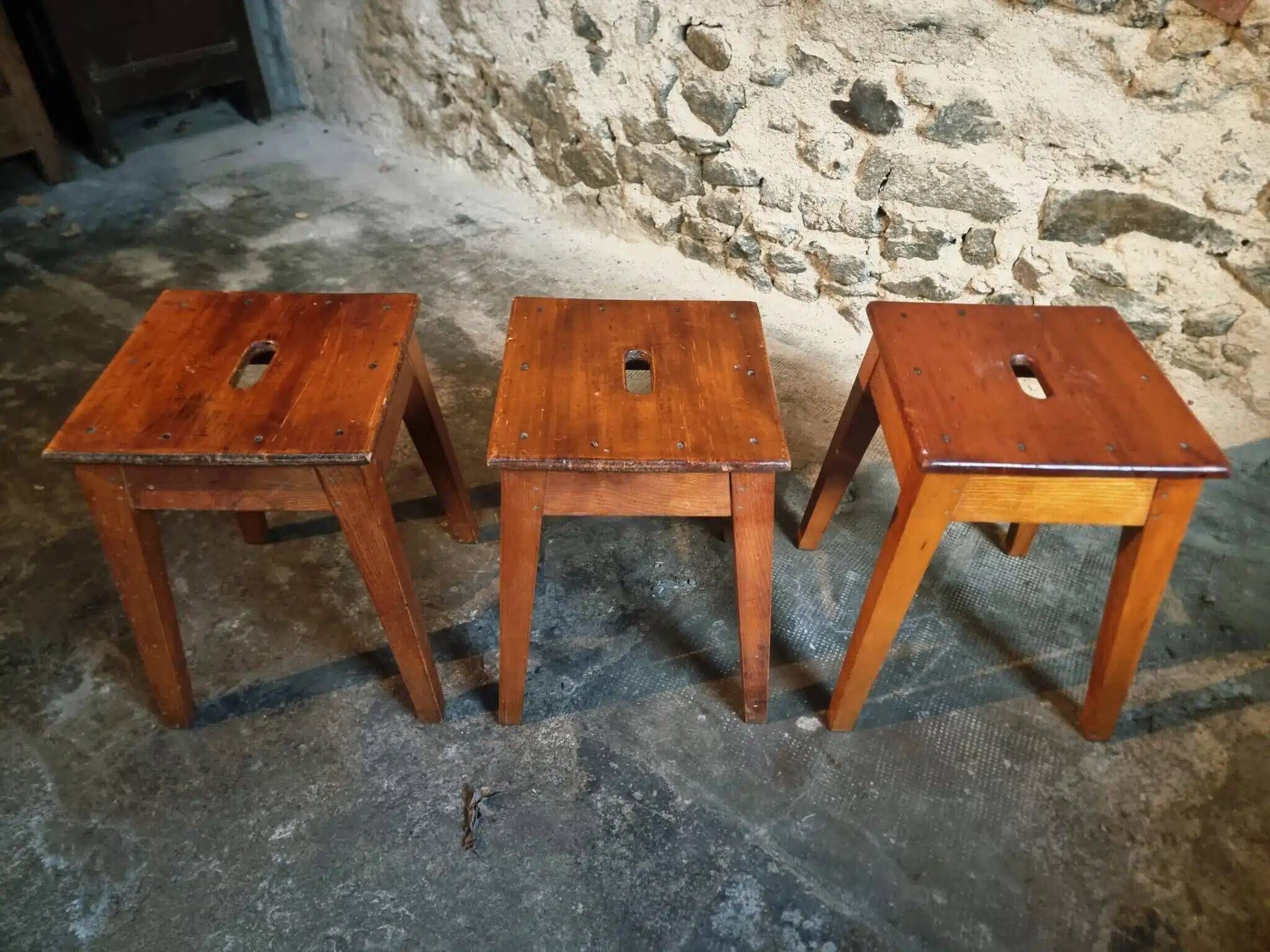Set of 3 vintage French wooden stools from the 1950s.