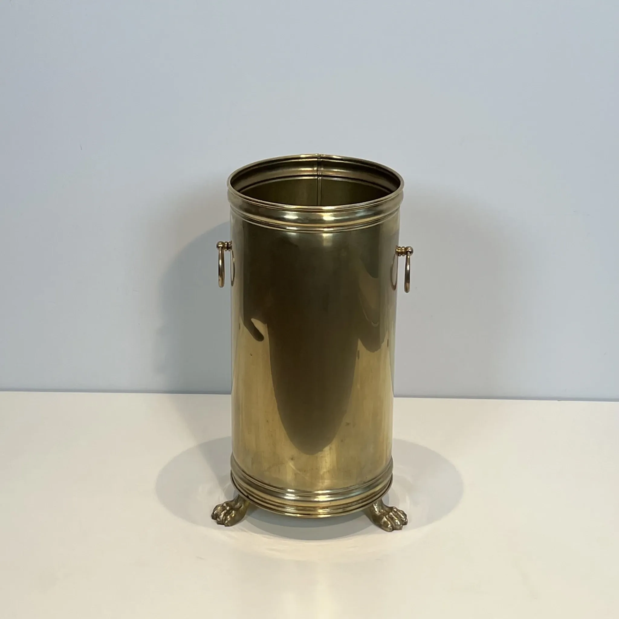Cylindrical Brass Umbrella Stand with Ring Handles and Claw Feet.