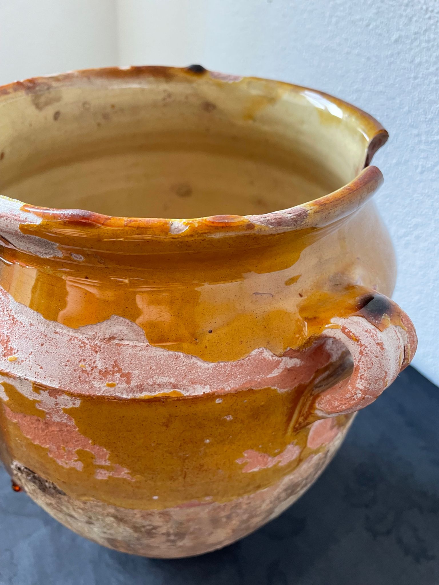 Old grease pot in glazed yellow terracotta, France nineteenth century