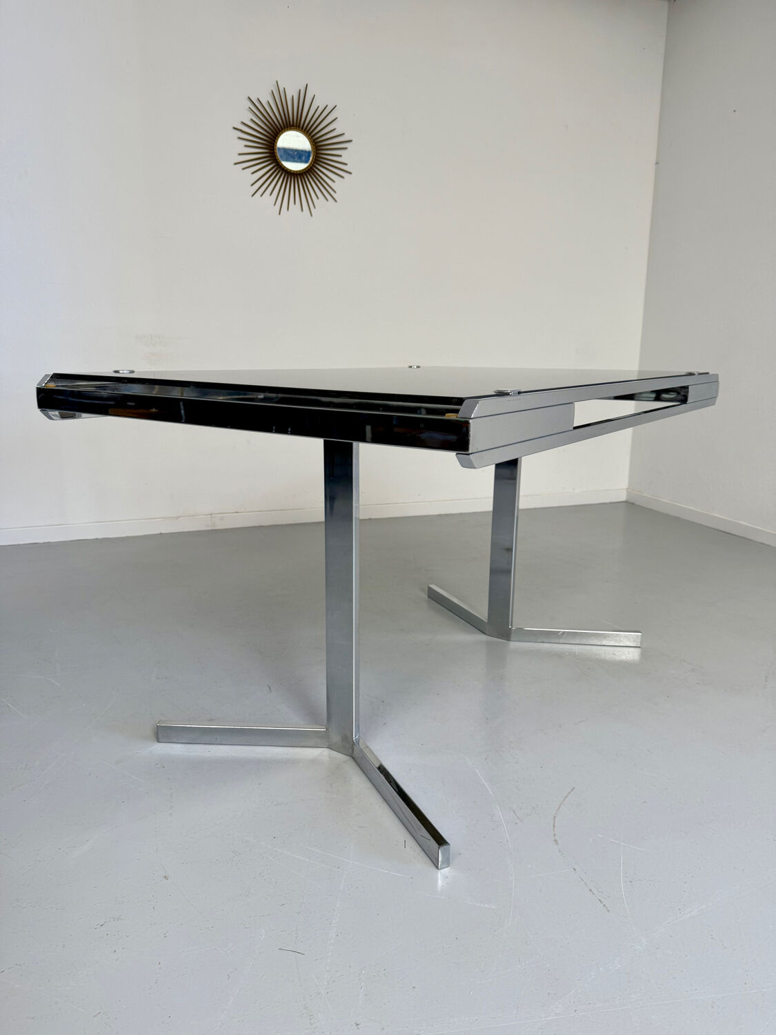 Smoked glass dining table with chrome legs, 1970s design by Roche Bobois.