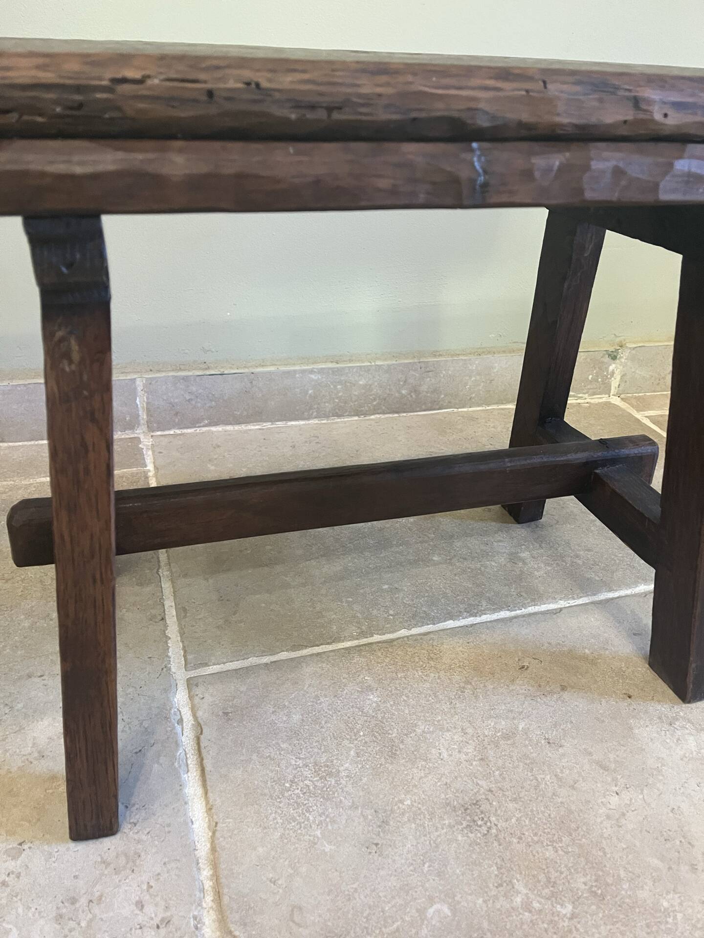 Small antique wooden bench with a folding backrest.