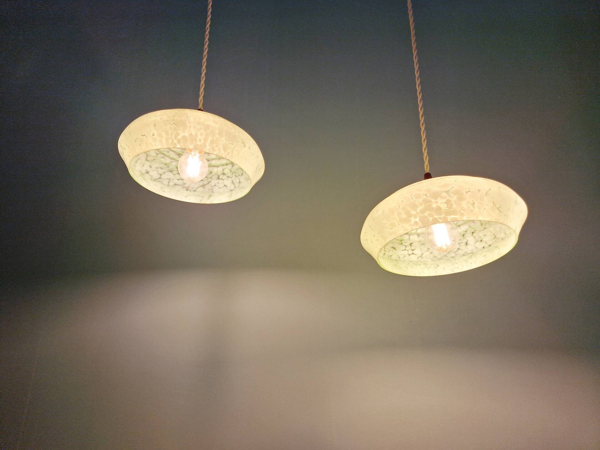 Pair of Art Deco light fixtures in light green speckled glass, 1930s.