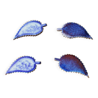 A set of 4 handcrafted pottery knife rests in blue.