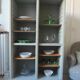 Vintage furniture transformed into a bookcase, verdigris patinated sideboard.