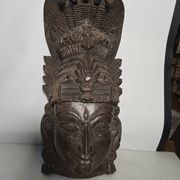Ancient Indian carved wooden mask sculpture of a deity with a cobra.