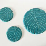 Ceramic trivet and bottle coaster from the 1950s.