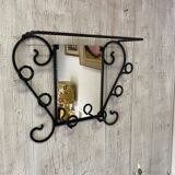 Wall-mounted coat rack with its mirror.