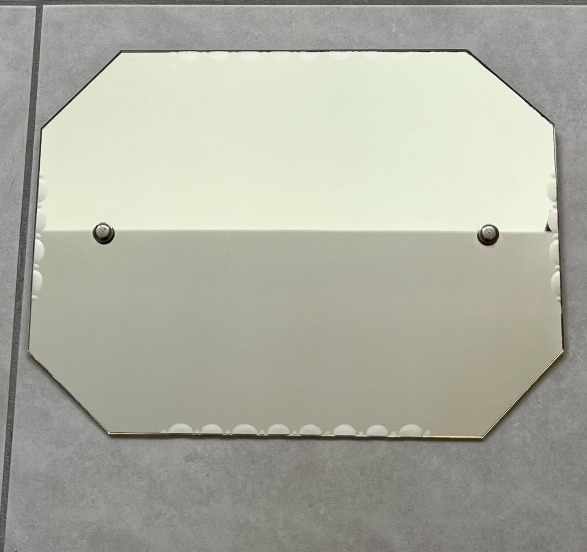 Small bevelled wall mirror from the 1940s.