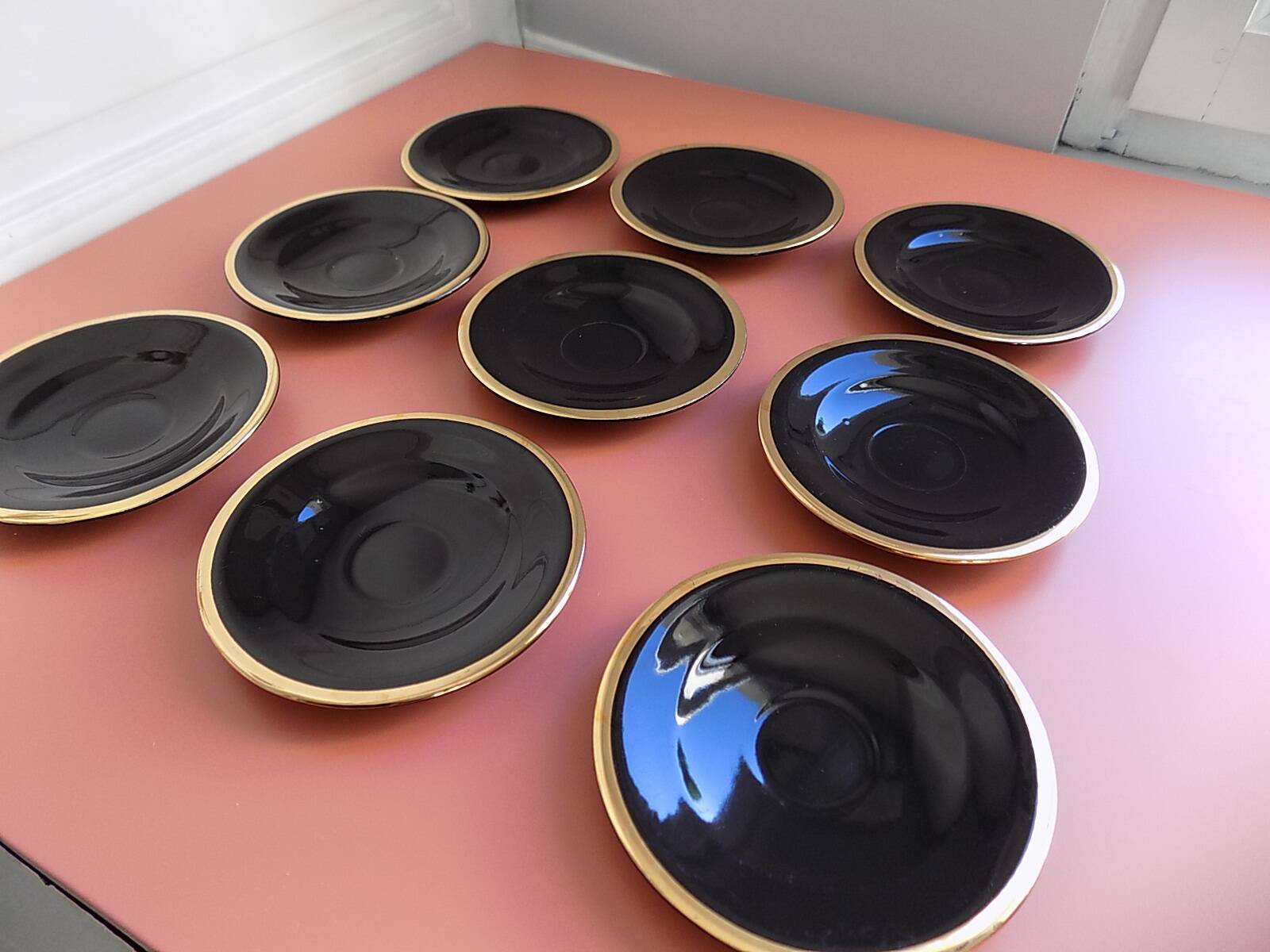 set of 9 black and gold Salins cups and saucers