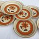 Set 11 plates 1970 Revernay Sarreguemines orange and brown on sandstone background