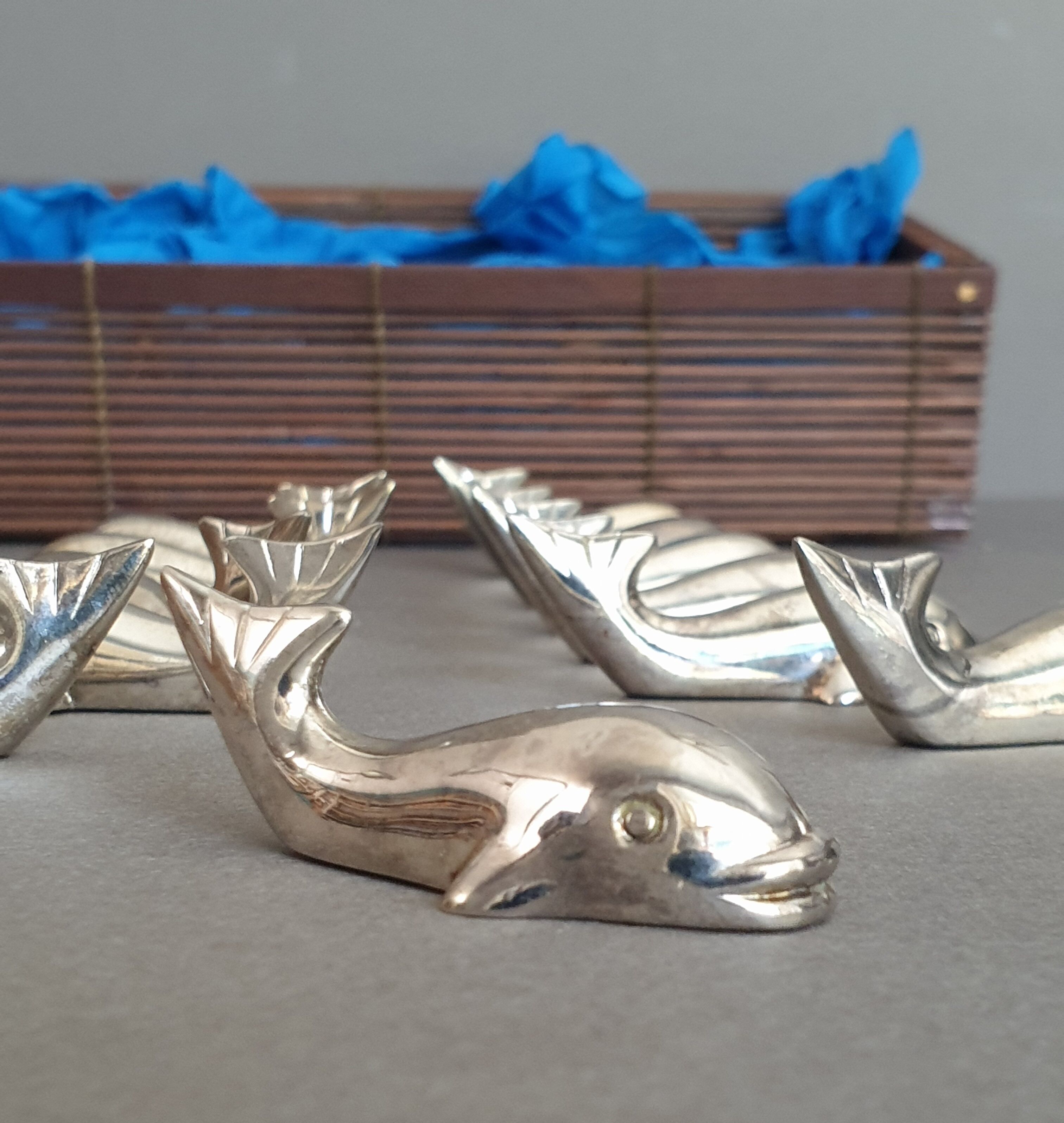 Lot 12 knife holders in the shape of a stylized whale or fish