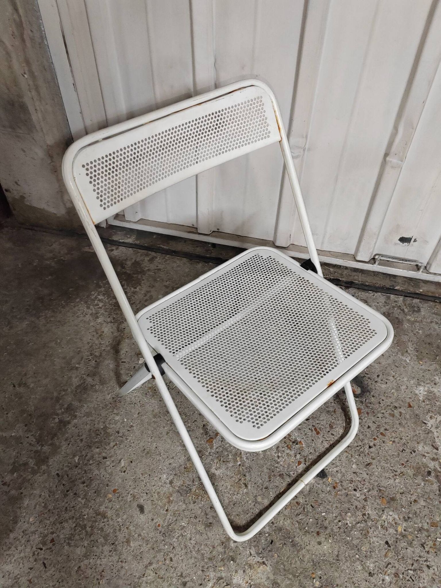 Perforated metal folding chair