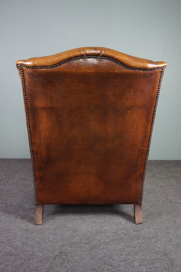 Eared armchair in patinated sheepskin