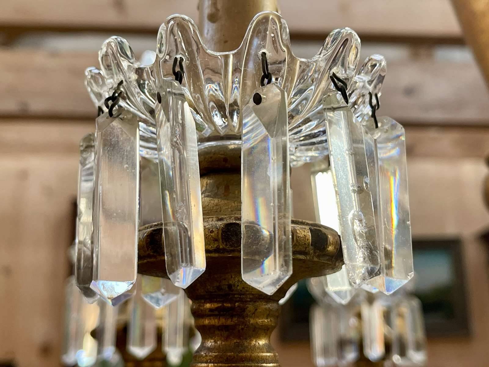 Golden wooden chandelier with crystal pendants from the 19th century.