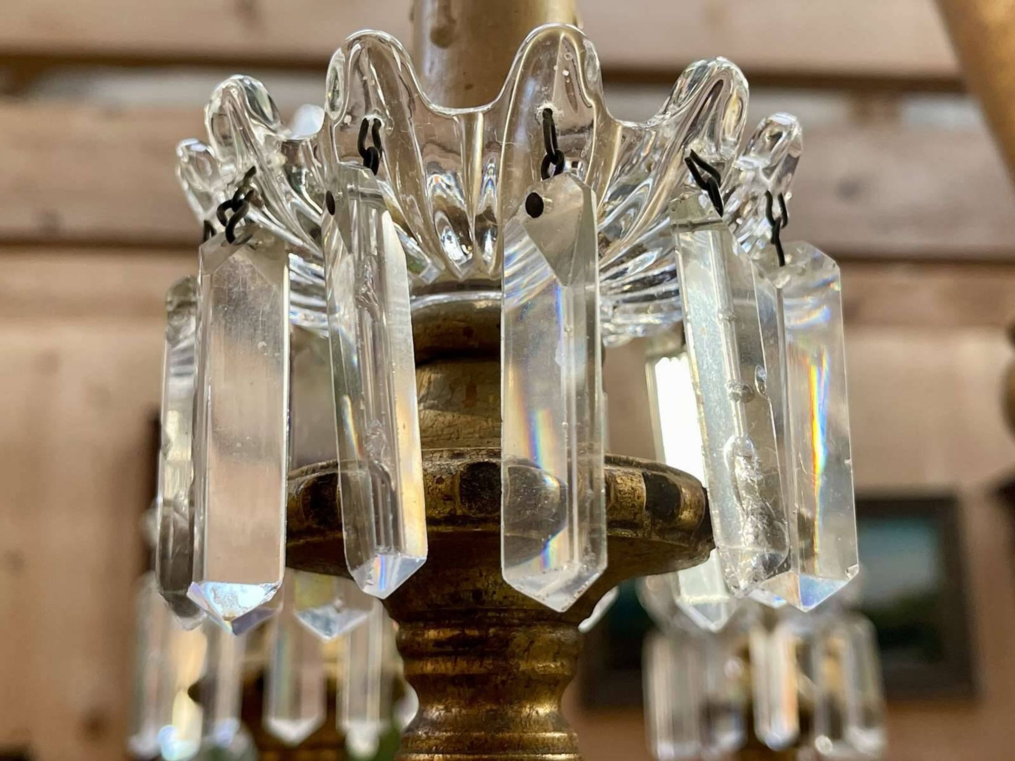 Golden wooden chandelier with crystal pendants from the 19th century.