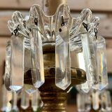 Golden wooden chandelier with crystal pendants from the 19th century.