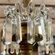 Golden wooden chandelier with crystal pendants from the 19th century.