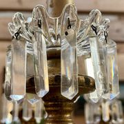 Golden wooden chandelier with crystal pendants from the 19th century.