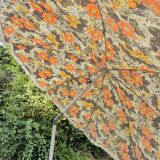Vintage parasol in brown orange flower canvas with fringes on the edge