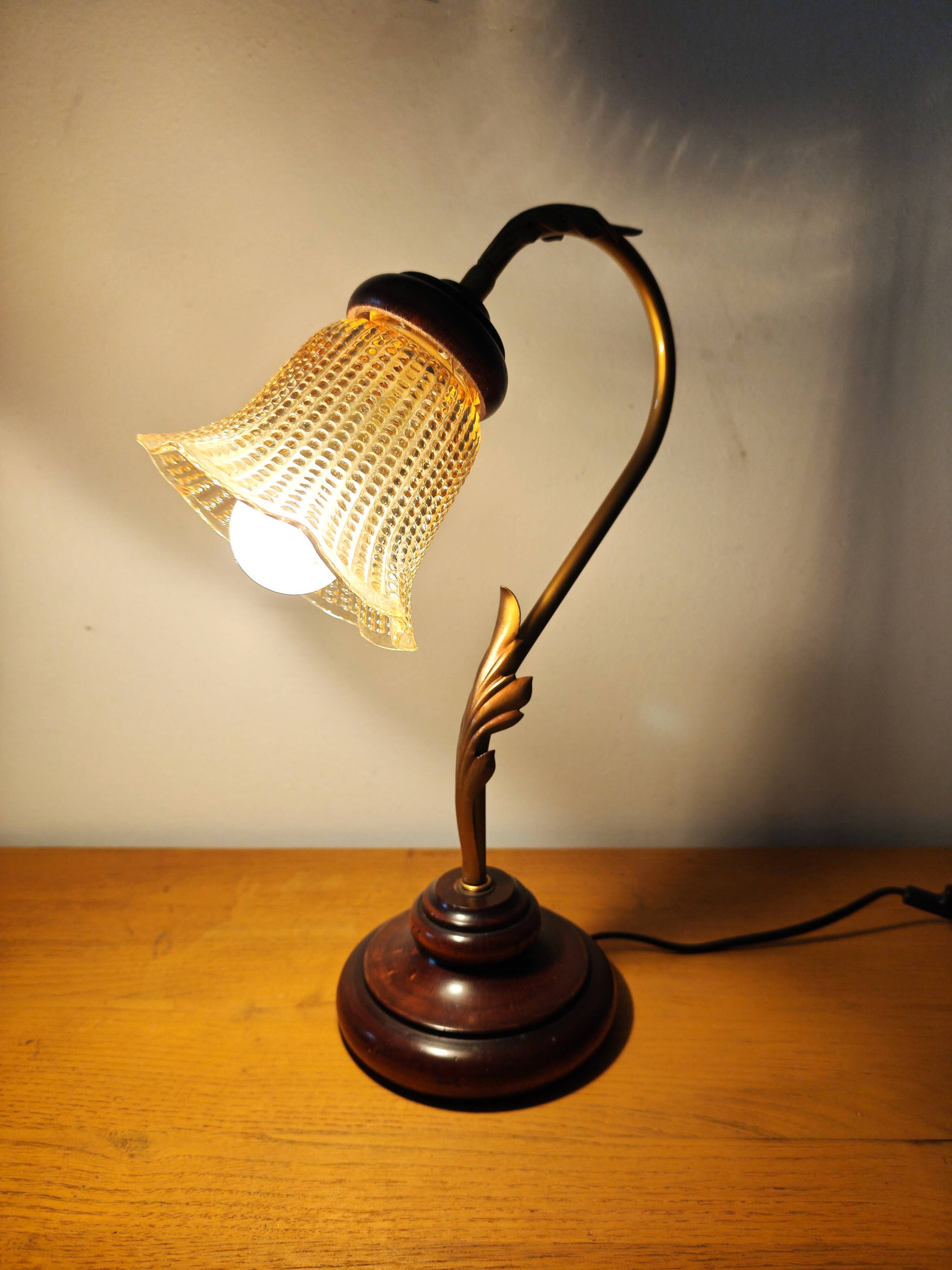 Gold swan neck table lamp with amber tulip glass.