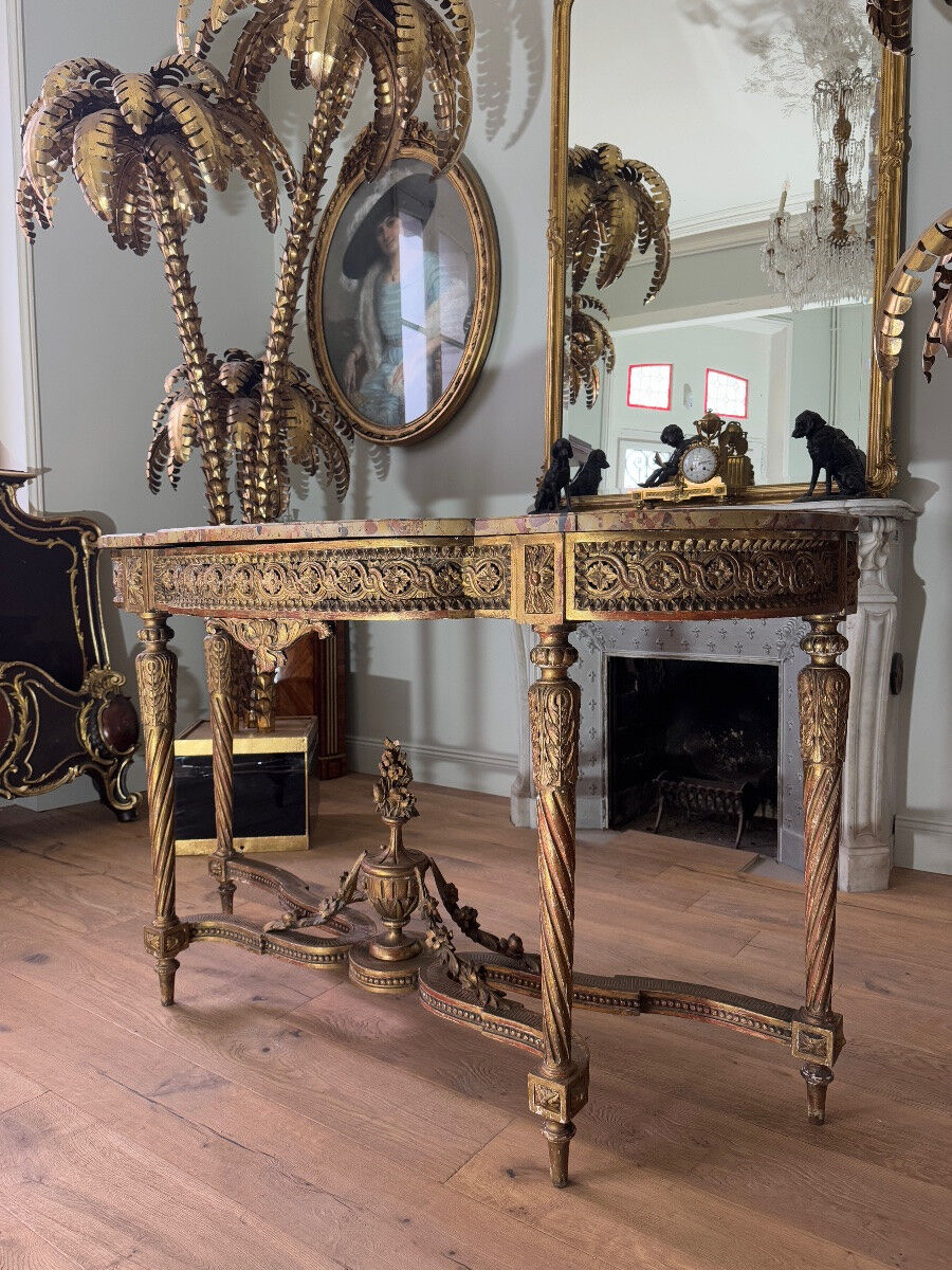 Console with 4 legs from the end of the 19th century in gilded wood in the Louis XVI style.
