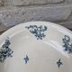 Shallow round plate Boch Frères model Regent with arabesque and foliage decoration.