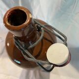 Old bottle in sandstone with a mechanical porcelein cap