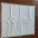 Ancient monogrammed pillowcase adorned with cotton lace