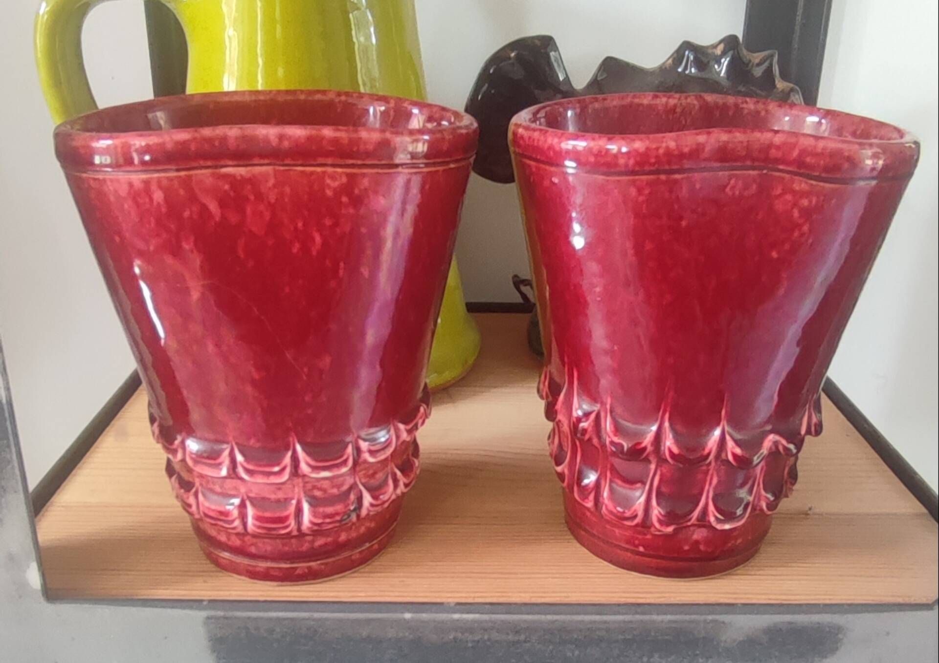 Pair of Art Deco asymmetrical red oxblood ceramic vases