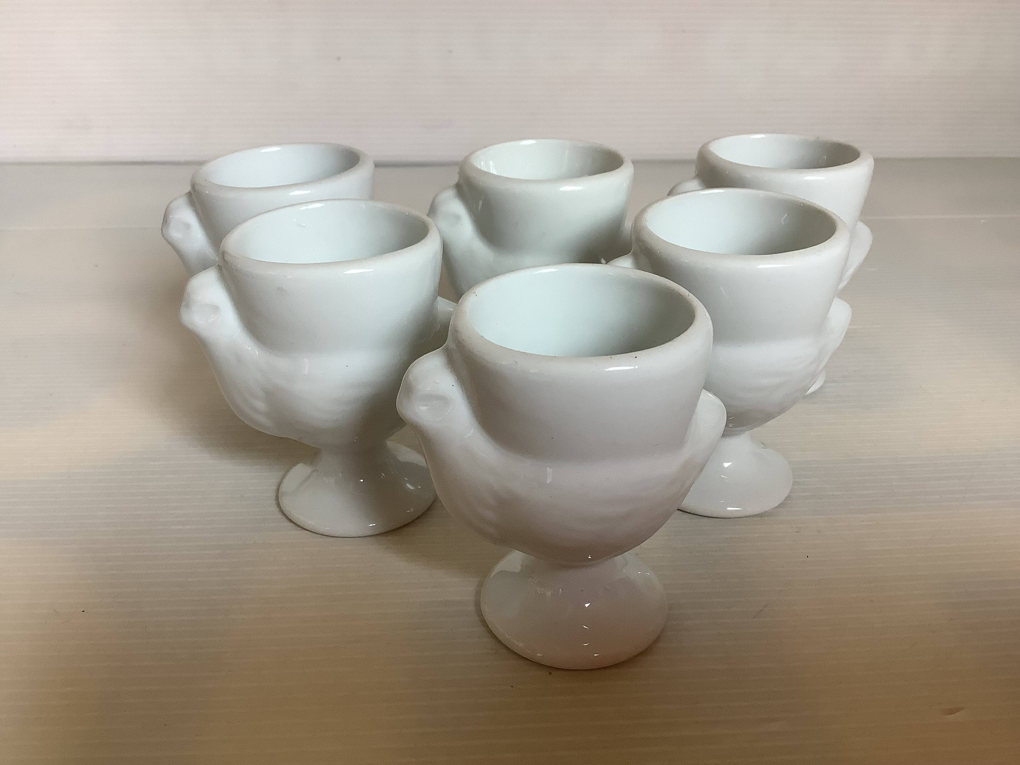 Six white hen egg cups